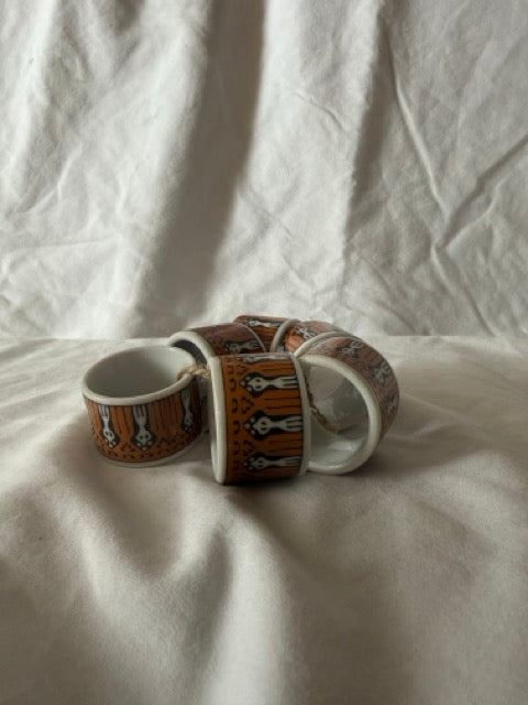 Set of six porcelain napkin rings with folk figures
