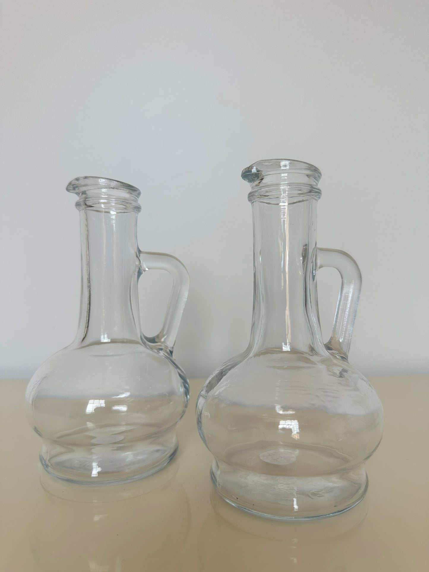 A set of Clear Glass Oil and Vinegar Cruet Bottles; marked Pasabache