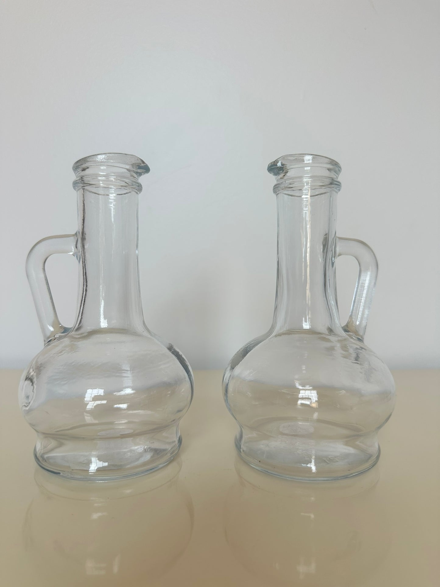 A set of Clear Glass Oil and Vinegar Cruet Bottles; marked Pasabache