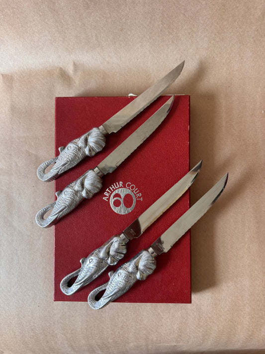 Four Arthur Court elephant steak knives on the original red box