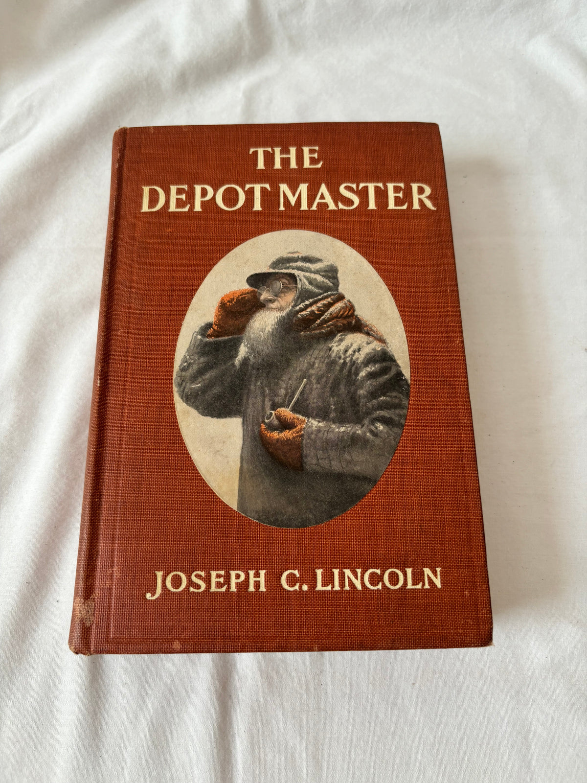 The Depot Master front cover, rust cloth with oval portrait
