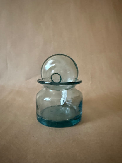 Aqua glass jar with the domed lid resting on the rim