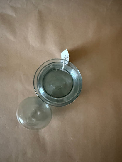 Overhead view of the open aqua glass jar and lid