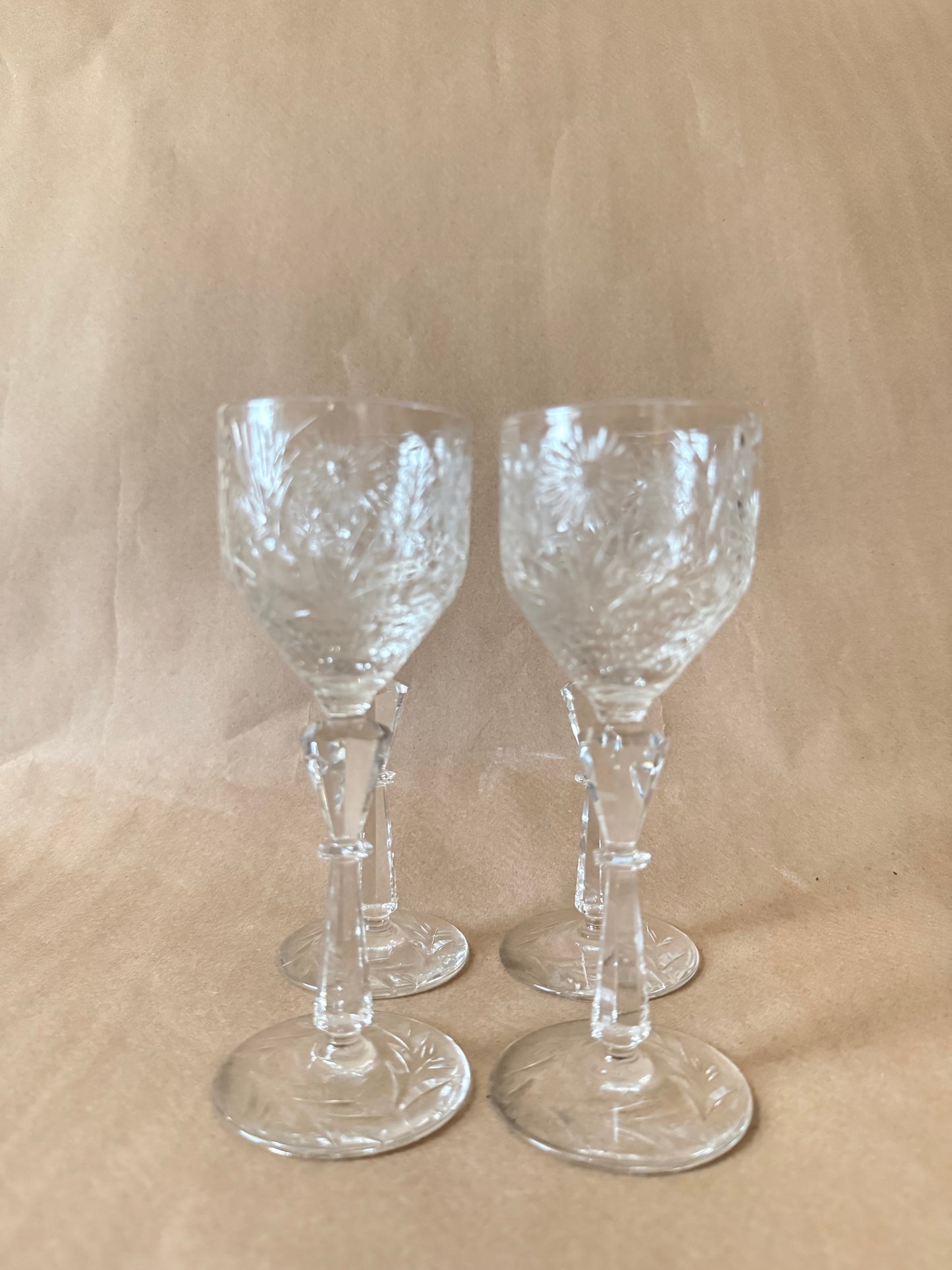 Four cut crystal cordial glasses grouped together