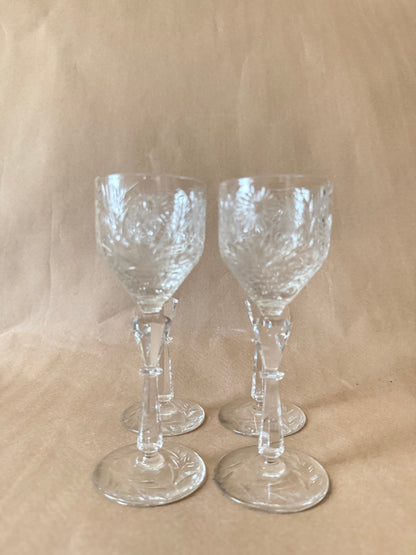 Four cut crystal cordial glasses grouped together