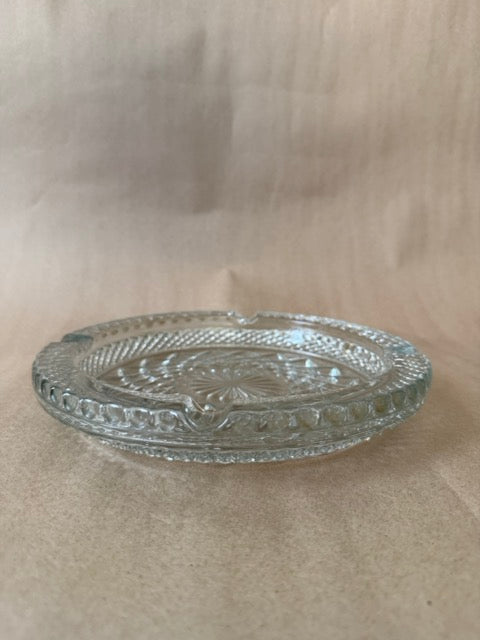 Clear pressed glass ashtray with diamond point pattern and beaded rim