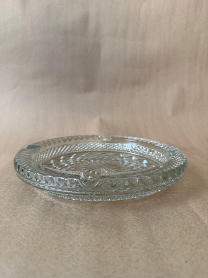 Clear pressed glass ashtray with diamond point pattern and beaded rim