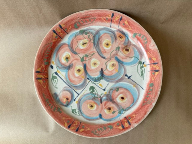 Hand-painted studio plate with coral rim and pink and blue blossoms