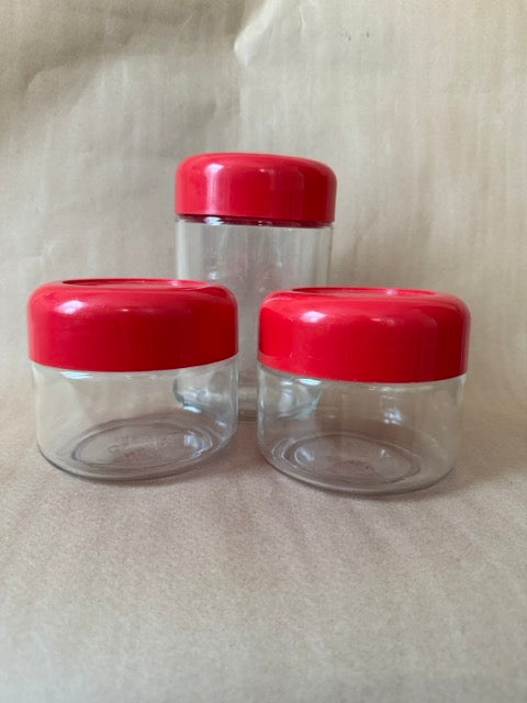 Set of three Heller glass canisters with red lids