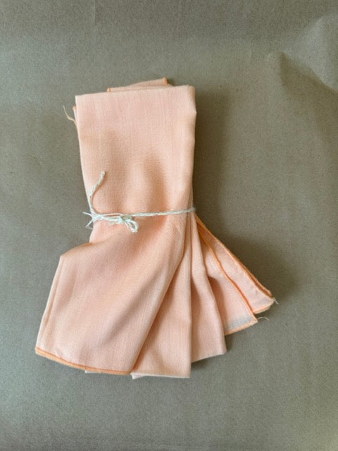Blush napkins, fanned to show rolled edges