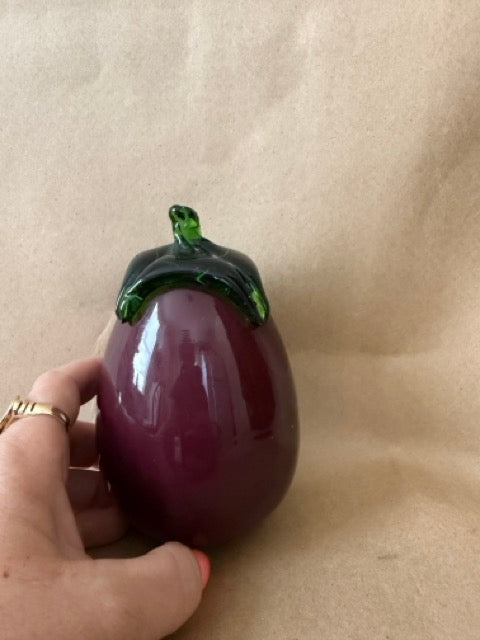 Glass eggplant in hand