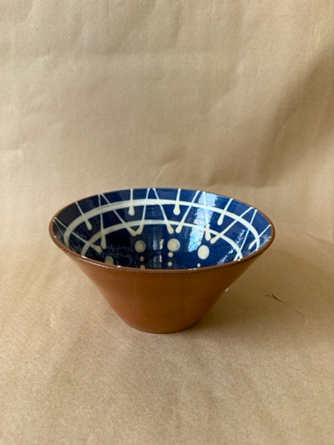 Studio pottery bowl with slip-trailed blue interior