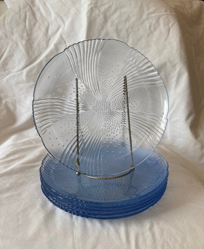 Blue swirl glass luncheon plate upright in front of the stacked set