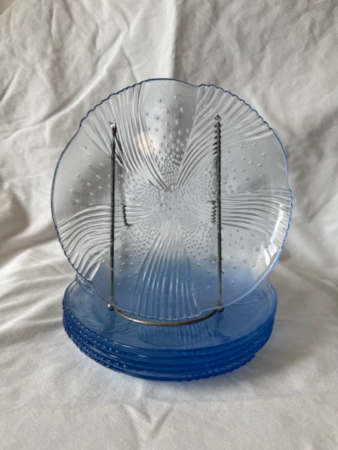 Blue swirl glass salad plate upright in front of the stacked set