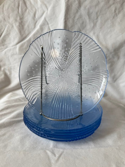 Blue swirl glass salad plate upright in front of the stacked set