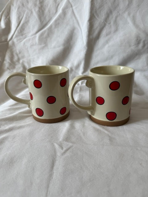 Pair of cream stoneware mugs with red polka dots
