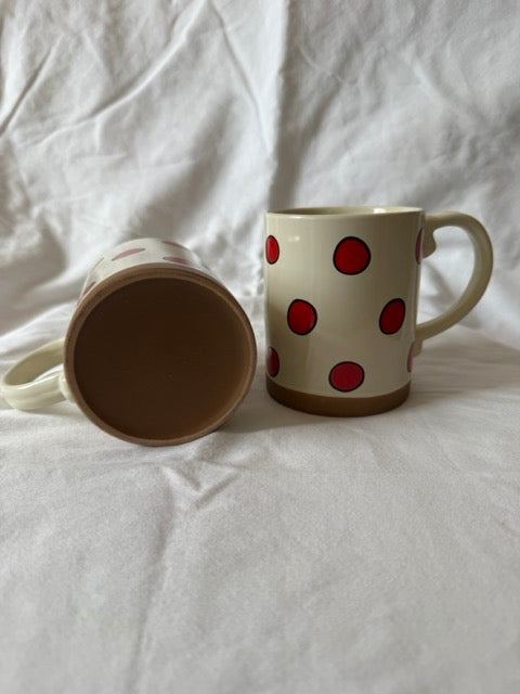 Red dot mug showing unglazed terracotta base