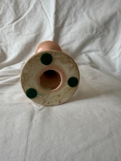 Base of peach candlestick with partial paper label