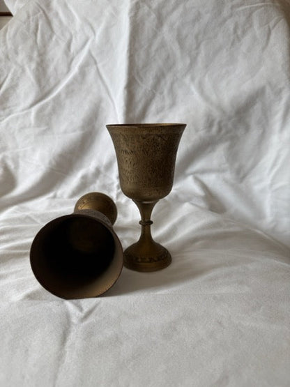 Brass goblet on its side beside its pair