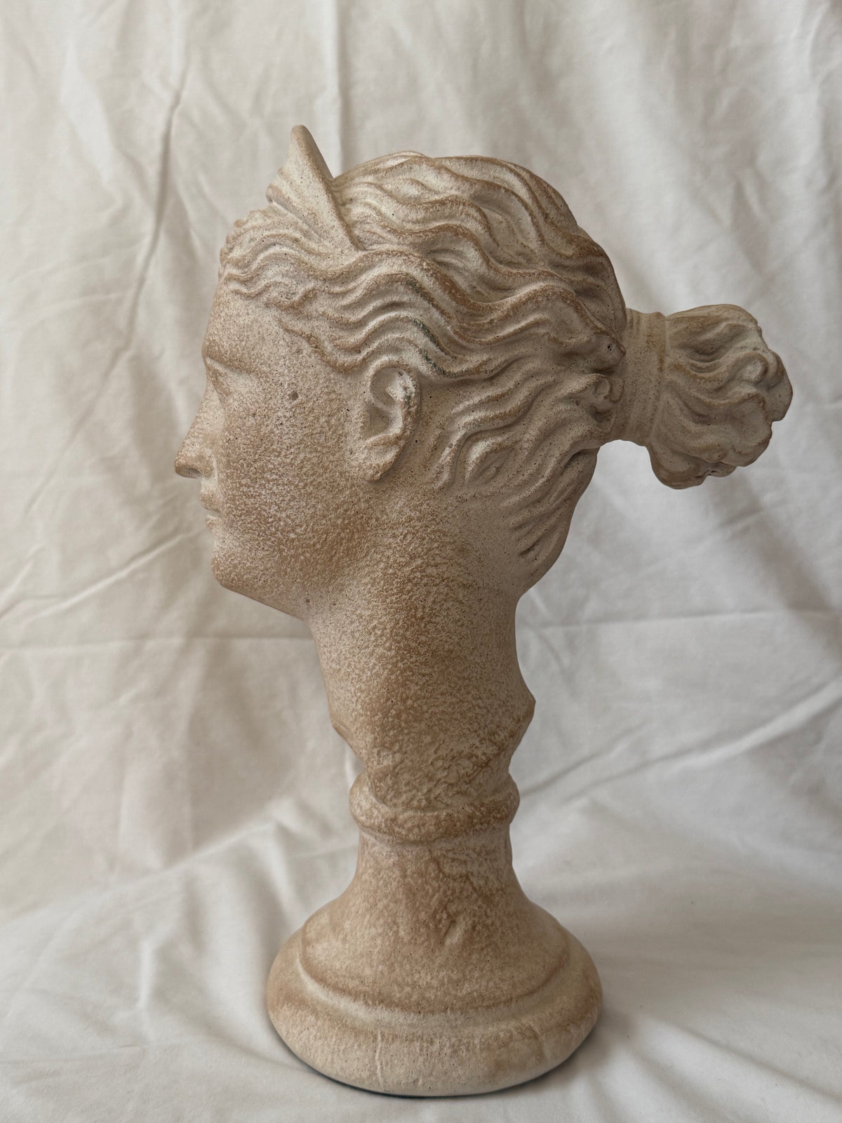 Goddess head, right profile with hair knot
