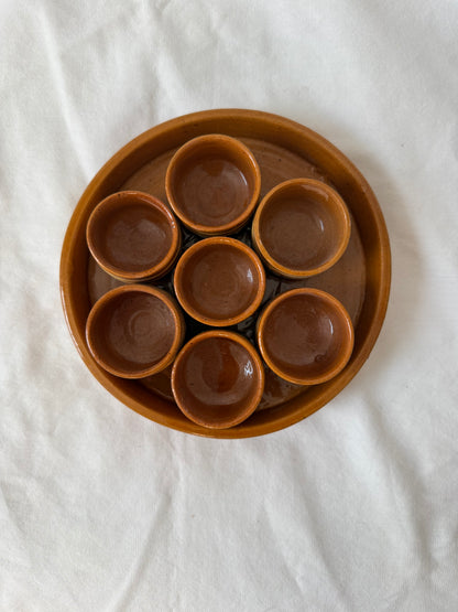Stoneware tray with seven condiment cups, from above