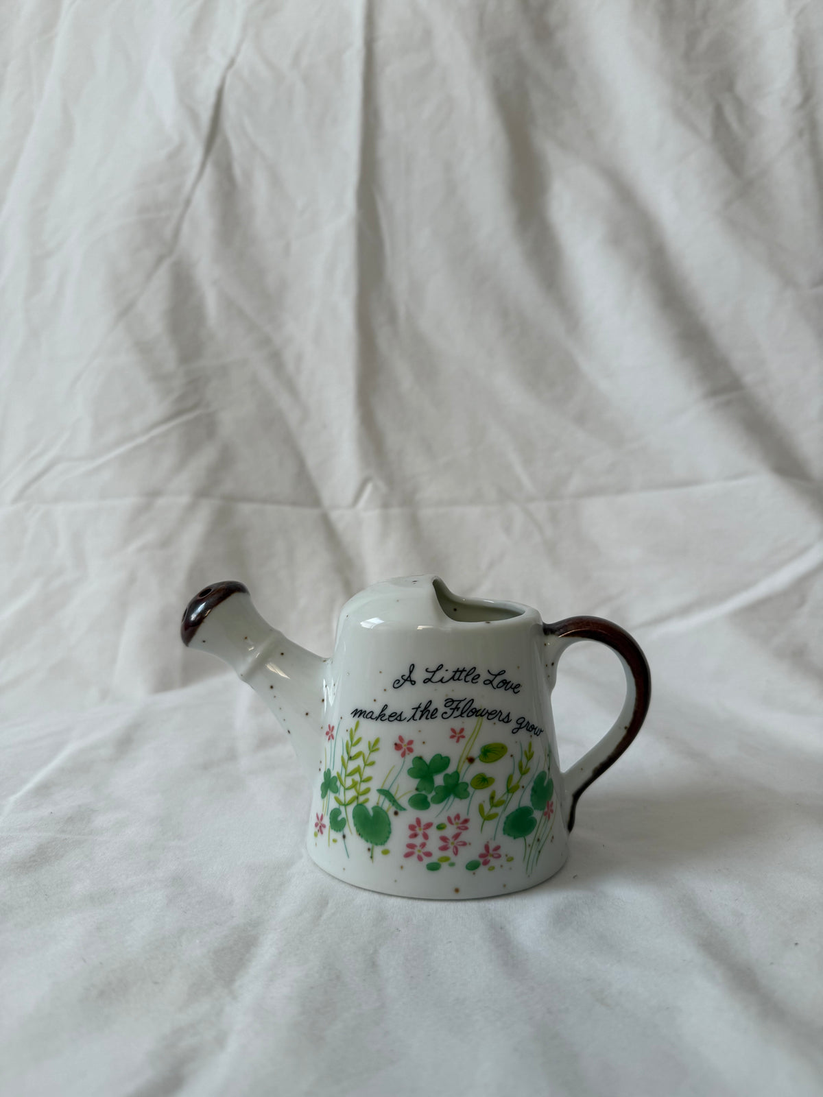 Ceramic watering can with flower lettering