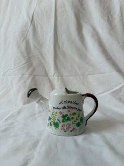 Ceramic watering can with flower lettering