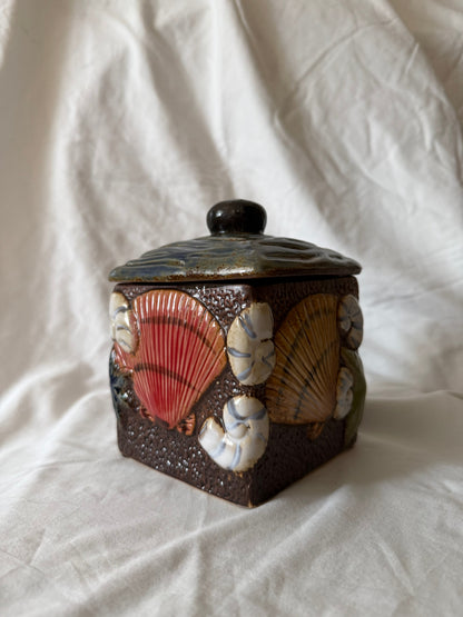 Square ceramic lidded jar with raised seashell decoration