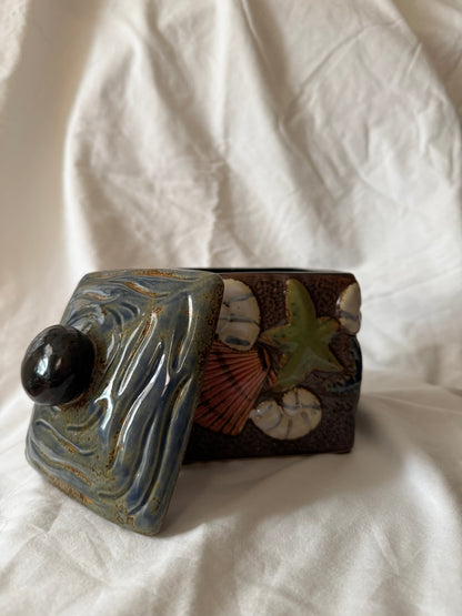 Jar with wave-textured blue lid removed