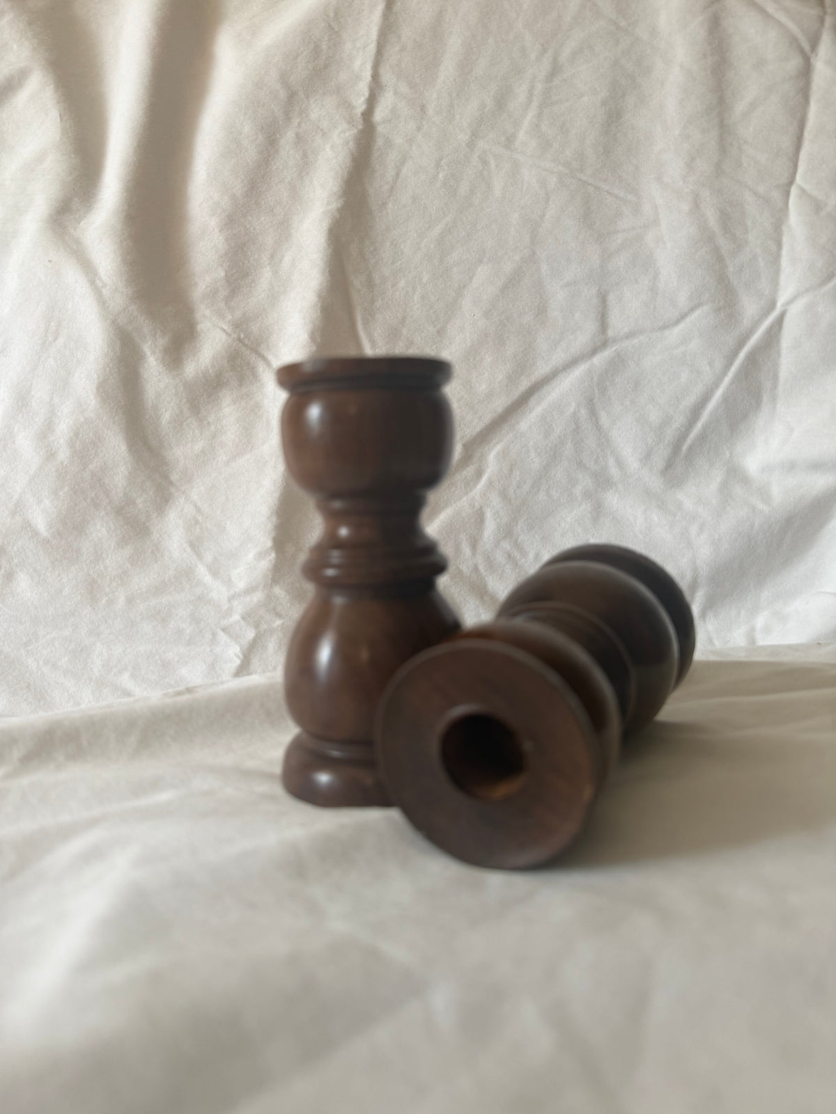 Turned wood candle holders showing candle cup