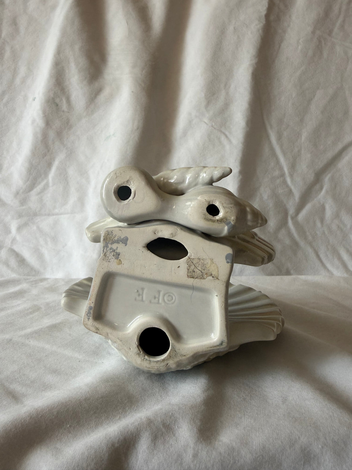 Base of shell letter holder showing maker's mark