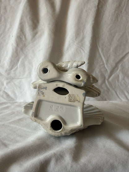 Base of shell letter holder showing maker's mark