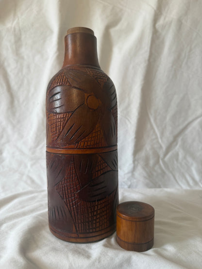Carved wood bottle with cap removed