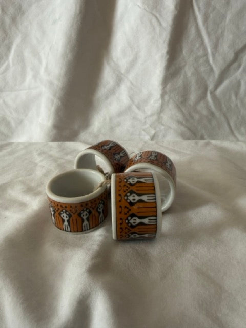 Set of four porcelain napkin rings with folk figures