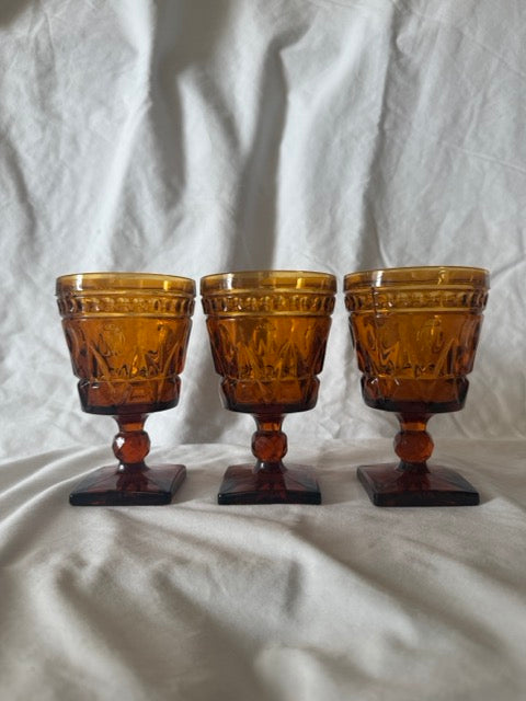 Three amber Park Lane goblets with square bases