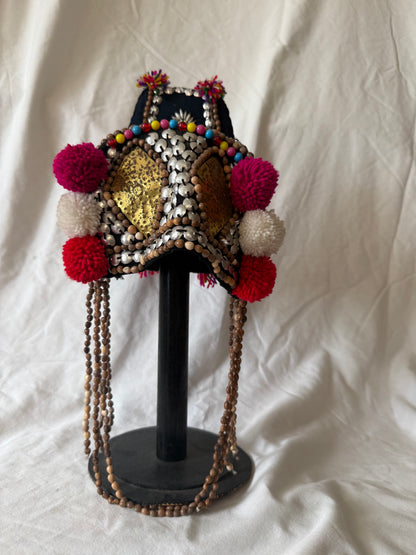 Akha-style beaded headdress with pom-poms